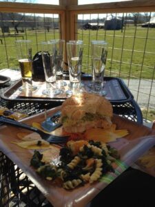 Light lunch eaten in the shade with wine on bistro table.