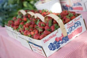 Overflowing basket of strawberries at market. 