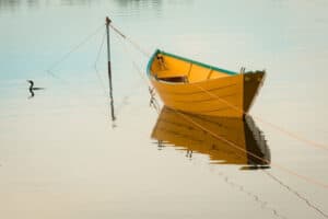 Yellow row boat in water. 