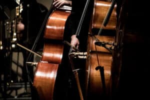 Stringed instruments being played with black background