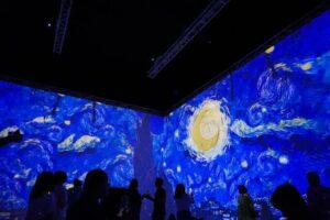 Van Gogh Starry nights with many viewers in dark room. 