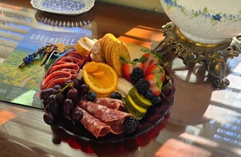 charcuterie board on desk with keys and map of Greenville