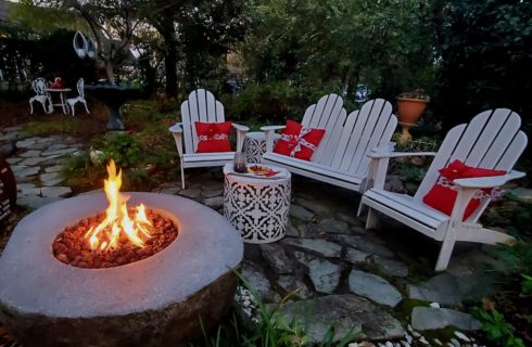 Crackling fire near seating area with wine and cheese tray.