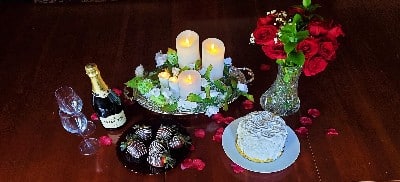 Romantic package including Champange, chocolate dipped strawberries, roses, flickering candle tray, and Strawberry Champagne cake.